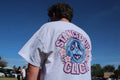 Back of the SUC Worldwide Cherry Blossom Limited Edition Tee in white, showing a chrome tri-spoke wheel framed by pink cherry blossoms and Stanced Up Click lettering